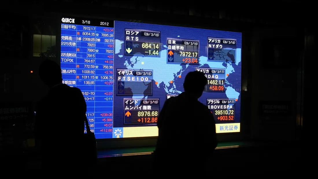 An electronic stock board glowing outside a station