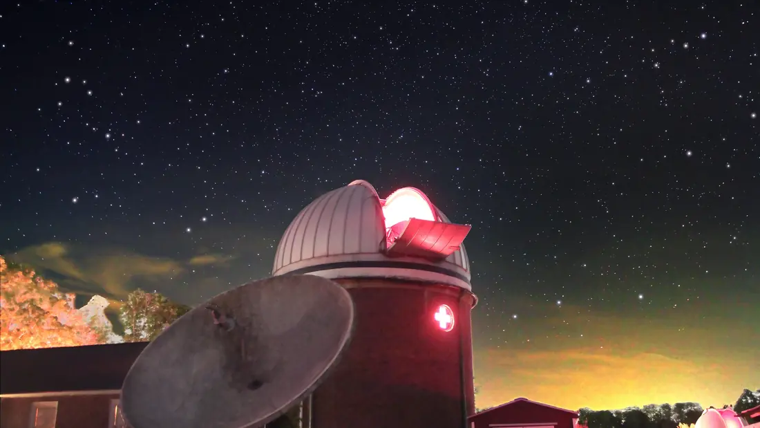 Technicians checking the mounting structure of a research telescope