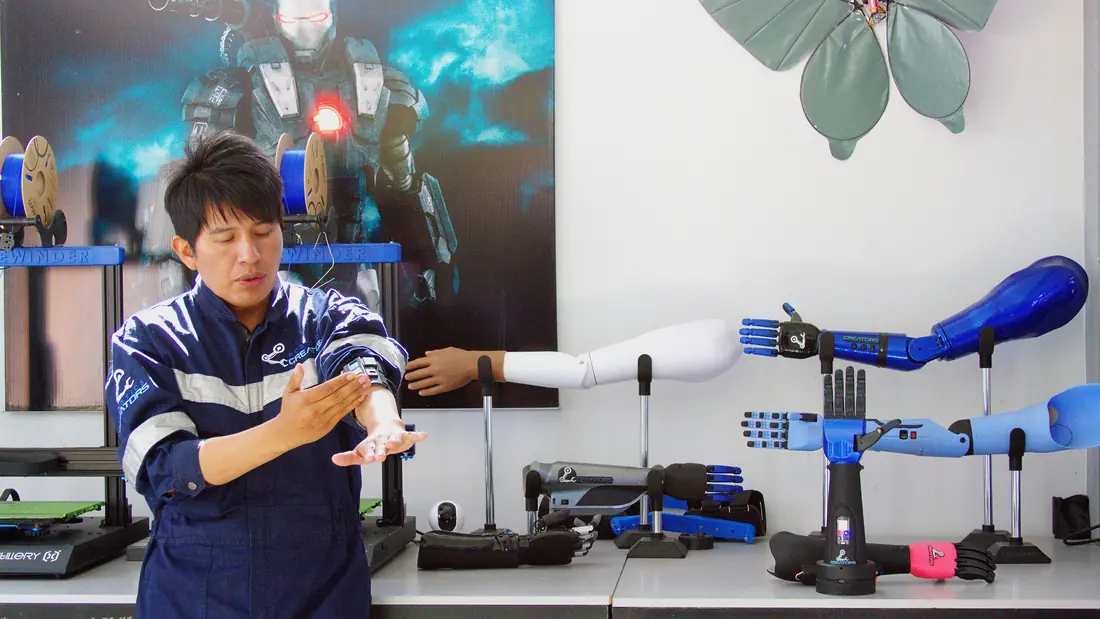 A robotics developer demonstrating a bionic prosthetic arm